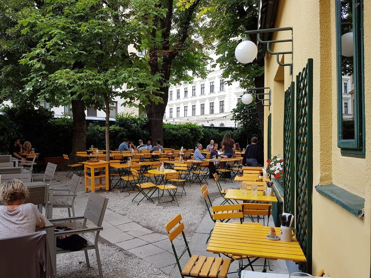 Interior of Fischerbräu brewery restaurant in Vienna – wooden tables and Brauhaus atmosphere
